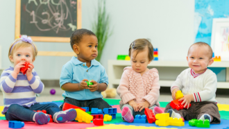 Four babies playing with blocks.