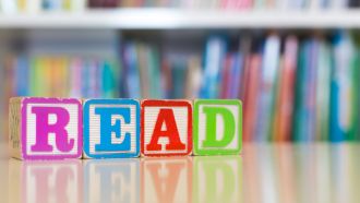 Colorful alphabet blocks spelling out "READ."