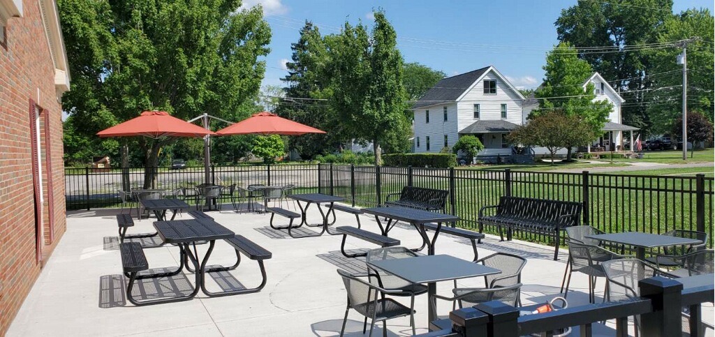 Outdoor patio area with benches and tables